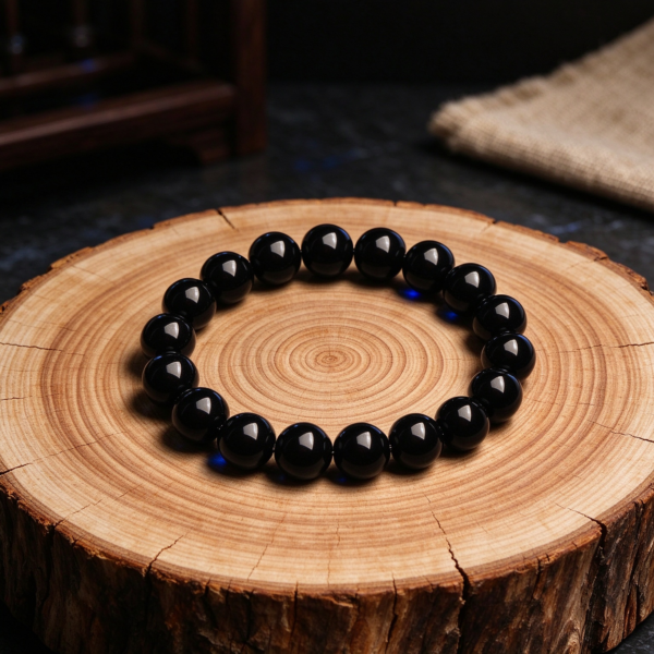 AI concept image: black obsidian bracelet on a wood slice